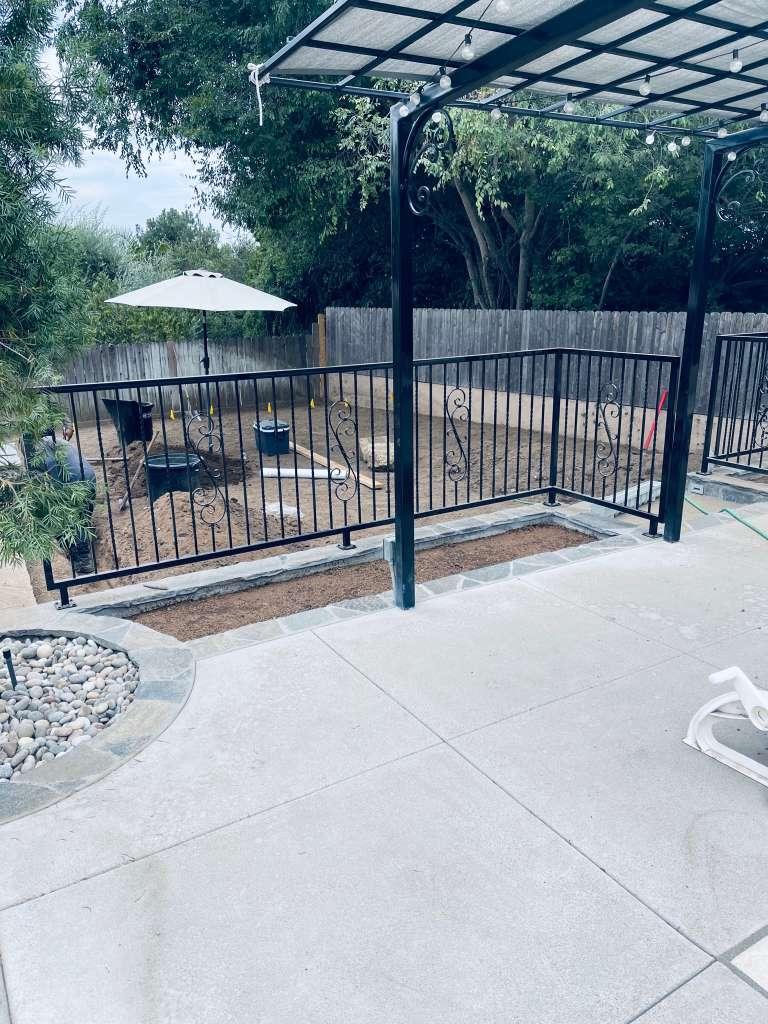 Exterior residential fence and gate feature with finished carpentry elements