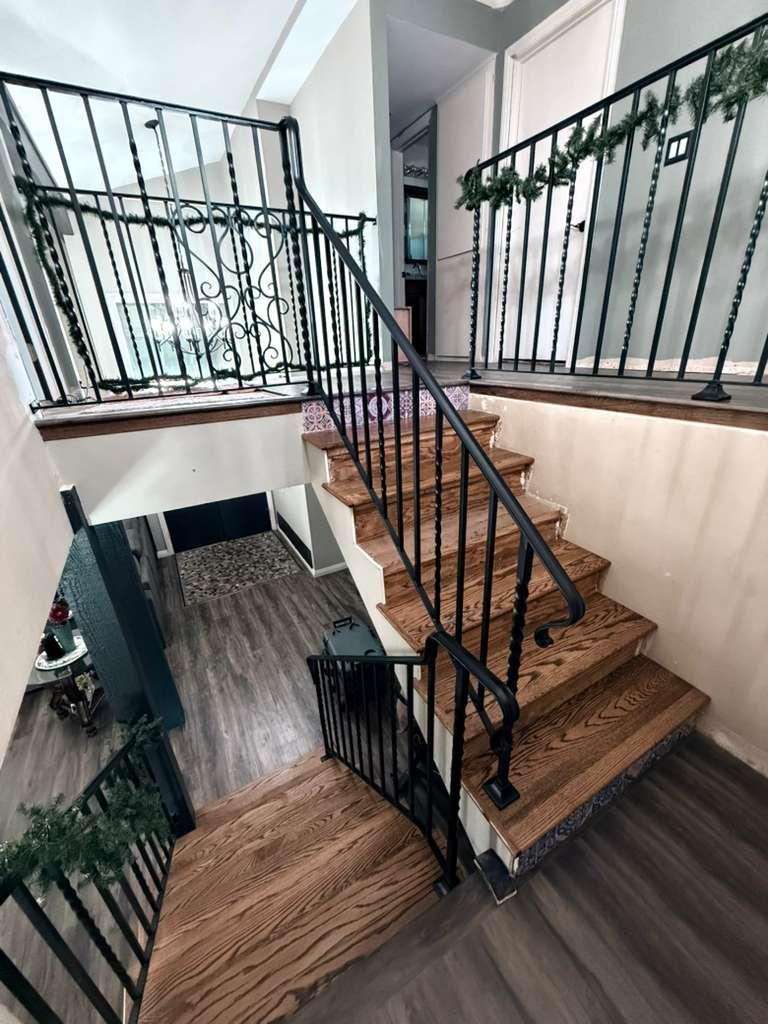 Black iron gate and railing installed at a residential property
