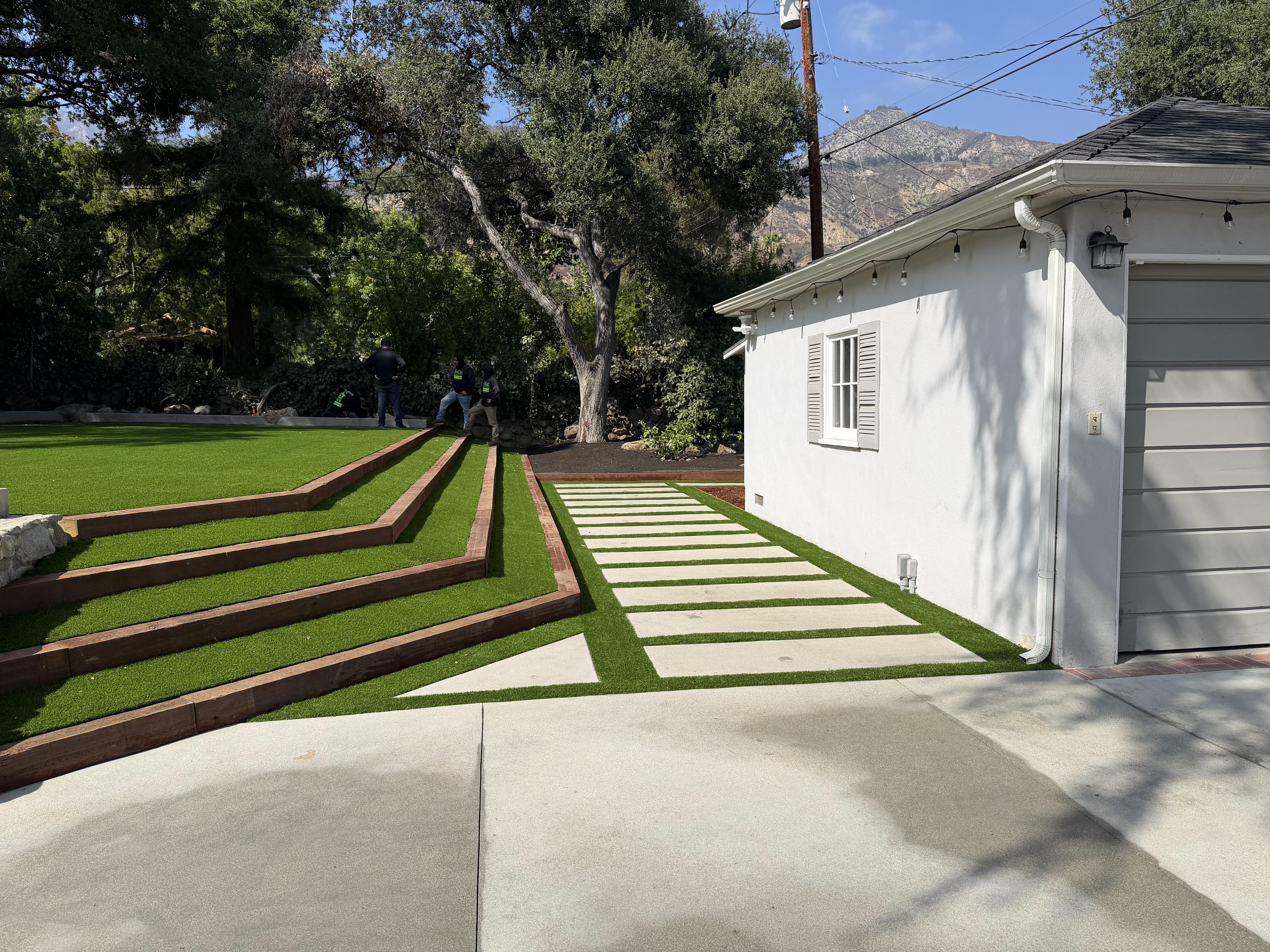 Cleaned up overgrown garden area with dense shrubs, planted and pruned new flowers, mature trees.