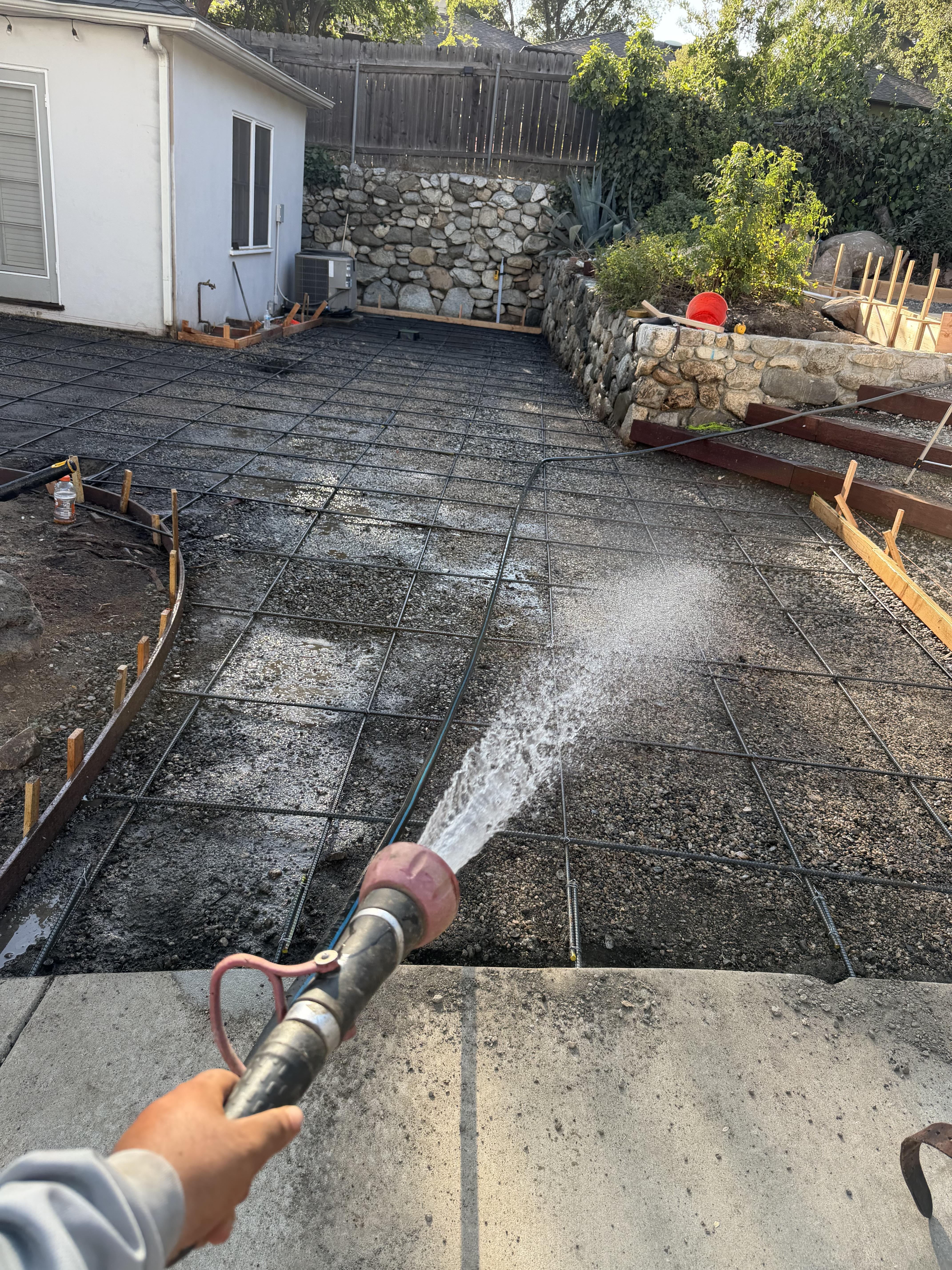 Finished concrete flatwork beside landscaped residential areas