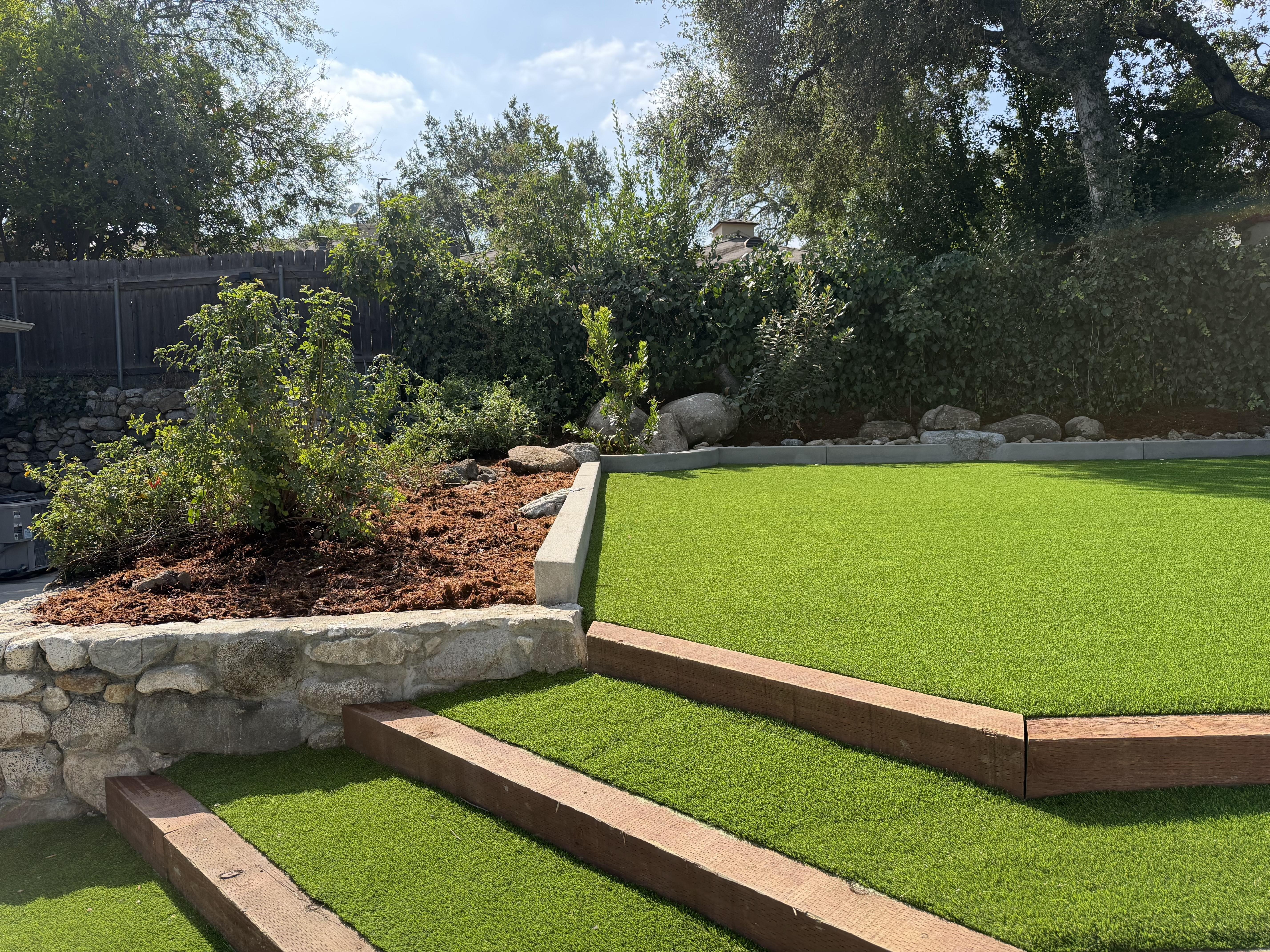 Cleaned up overgrown garden area with dense shrubs, planted and pruned new flowers, mature trees.