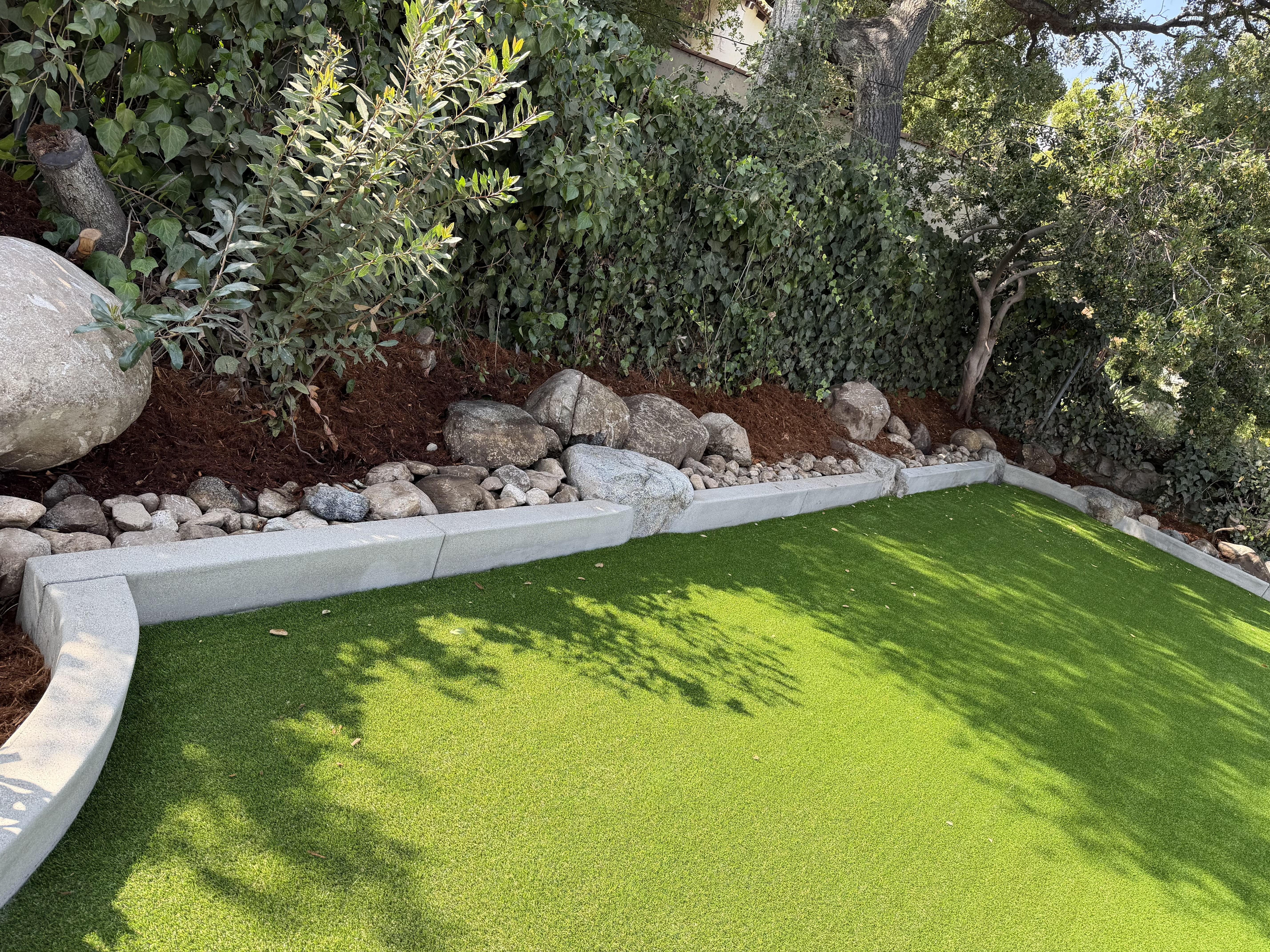 Cleaned up overgrown garden area with dense shrubs, planted and pruned new flowers, mature trees.