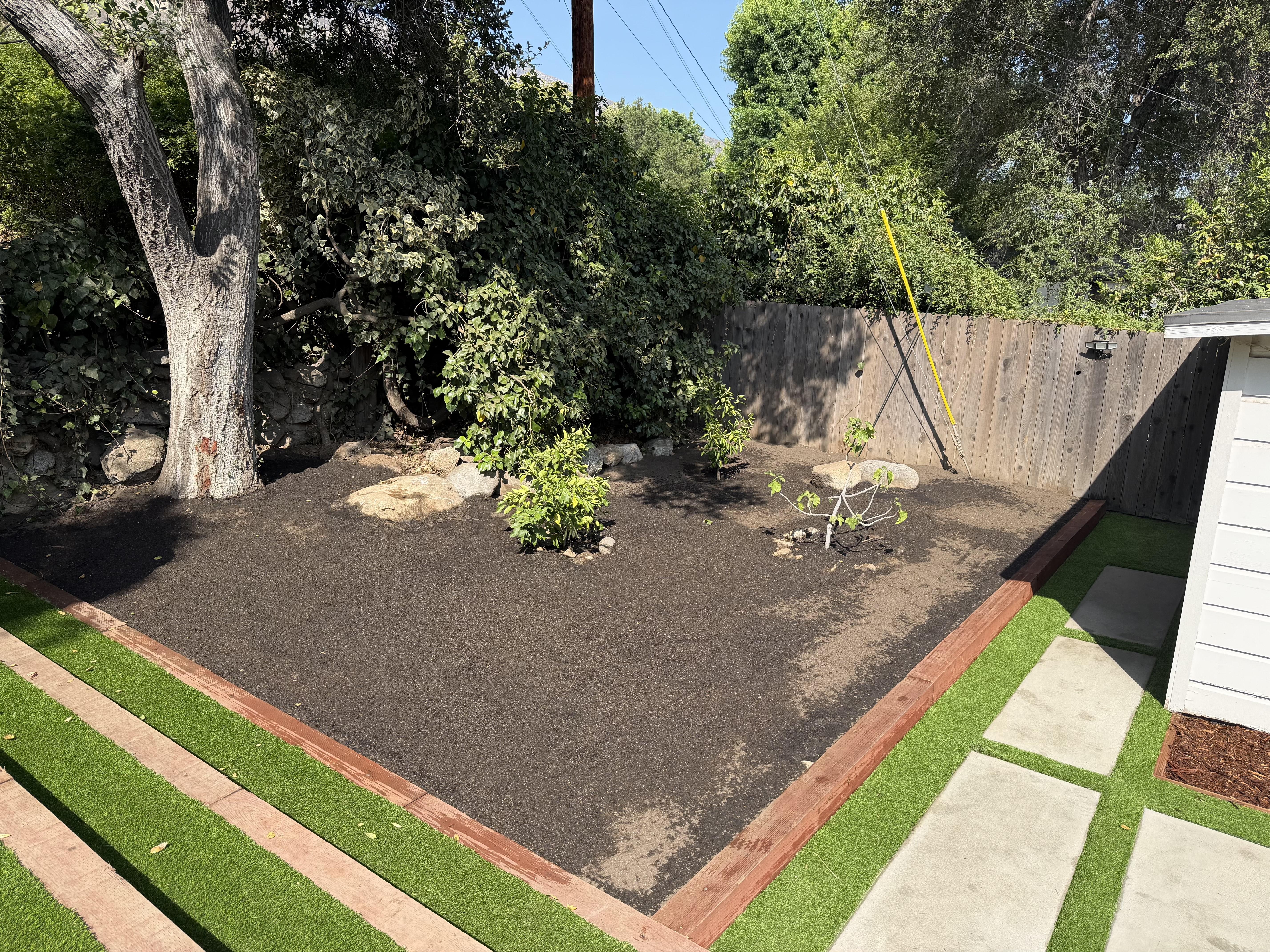 Cleaned up overgrown garden area with dense shrubs, planted and pruned new flowers, mature trees.